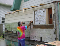 man pulling siding